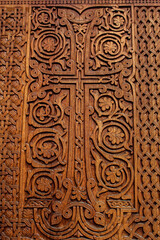 Cross on wooden door of temple, manual work