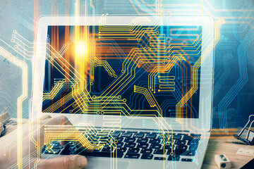 Double exposure of world map hologram with man working on computer on background. Concept of worldwideweb.