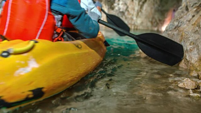Kayaking among rocks formations in underground lake of Peca, Slovenia.