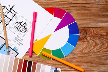 Color palettes with building plan on wooden background