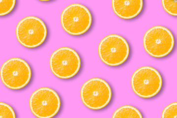 Seamless pattern of juicy orange slices on a pink background. Flat lay top view.