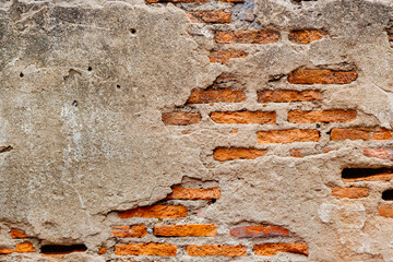Weathered old ruin concrete wall reveal brick cracked inside grunge aged building texture for background.