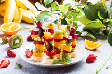 Fresh fruit on skewers. Concept buffet for a summer party.