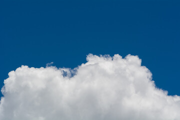 Clouds cover half of the frame with the blue sky in the other half.