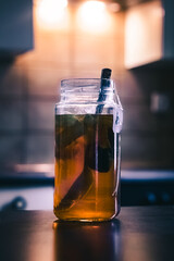 Black Tea with Lime Slices and Ice Cubes in a Jar