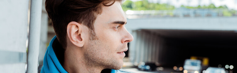Horizontal image of man looking away on urban street