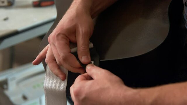 installing a guitar strap on a a knob for the guitar strap on the back of the guitar