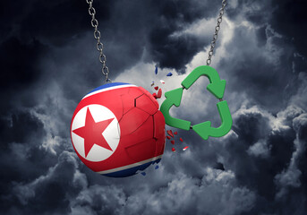 Obraz premium Green recycle symbol crashing into a North Korea flag ball. 3D Rendering