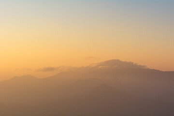 Mountain range with some clouds during golden hour in the morning