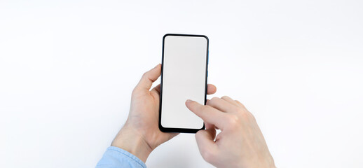 Male hands holding smartphone with blank screen on white background. Take your screen to put on advertising