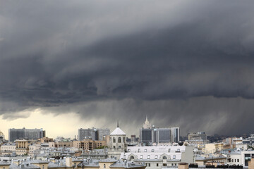 urban cityscape panorama day view of buildings, monuments, roofs, rooftops on a dark stormy sky and...