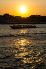 Silhouette of ferry boat and shore line in the evenging
