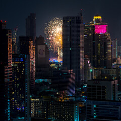 Fototapeta na wymiar Firework display in the middle of Bangkok for New Year celebrations. 