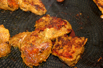 grilled chicken breast marinated in Indian spices cooking on a pan 