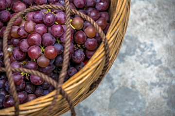 Shot of fresh grapes in a basket on the ground