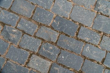 Background image of texture of a pedestrian road paved with paving stones