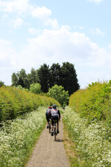 A man and woman cycling in the countryside training for a competition, the tour de France and tour de Yorkshire 