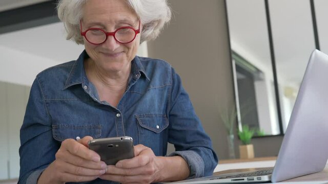 Portrait of senior woman using smartphone