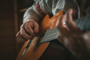 Hands on the strings of the guitar