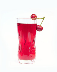 glass cherry juice and ripe and juicy cherry with green leaves on white background
