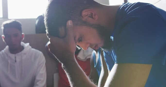 Thoughtful soccer player in the locker room