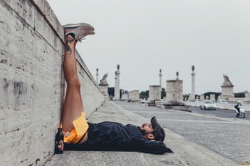 giovane atleta concentrato con le gambe poggiate al muro durante una sessione di allenamento in...