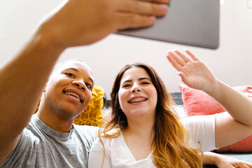 Interracial couple making a video call at home