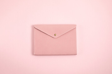Notebook over pink pastel background. Studing, reading, relaxing cncept. Monochrome minimal mockup