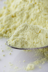 purified sulfur powder on a white acrylic background