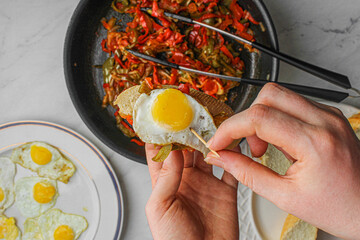 Basque pintxo made with onion, red & green pepper topper with a small fried egg.