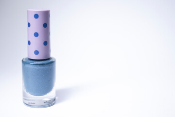 A bottle with blue nail polish on white background. nail lacquer. Nail manicure concept. Isolated, copy space. 