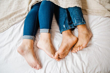 Interracial couple feet lying in bed