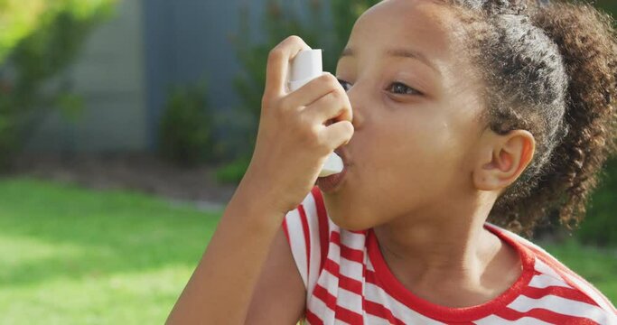 African american girl taking medicines for asmatics 