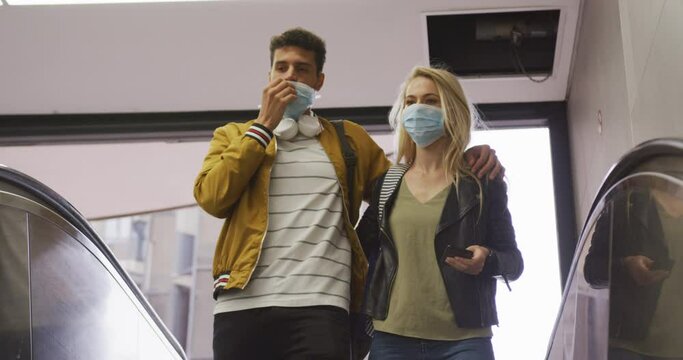 Caucasian couple on the go wearing a coronavirus covid19 mask