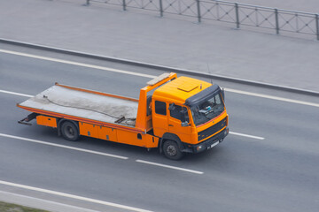 Empty tow truck rides on the highway.