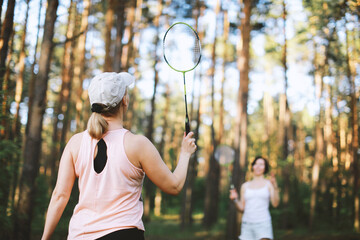 Two women plaining in bambinton in forest