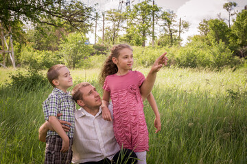 A beautiful young man with his young children in the Park.The concept of a happy family! Happy...