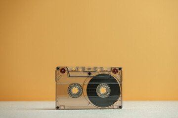 Close up Audio cassette tape on a white table and yellow space.Minimalism retro style concept. 80s....
