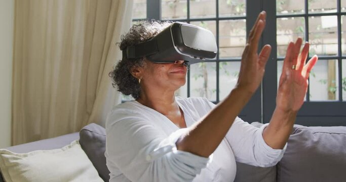 Senior mixed race woman wearing a vr headset. Social distancing and self isolation in quarantine 