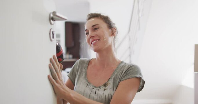 Portrait of a Caucasian woman in quarantine during coronavirus pandemic, doing interior work