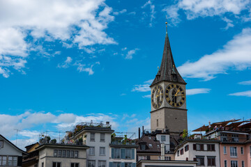 Old medieval church towers in Zurich city Switzerland summer day white clouds