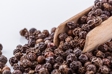 fragrant black pepper on white acrylic background