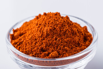 aromatic spicy chili powder on a white background
