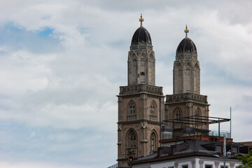 Fototapeta na wymiar Old medieval church towers in Zurich city Switzerland summer day white clouds