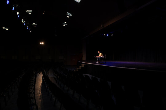Distant view of student practicing at the theater