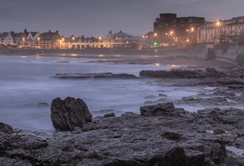 Pre Dawn Waves Against a Seaside Town
