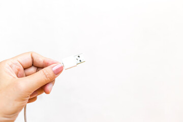 Hand holding USB port on white background, technology equipment, outdoor day light