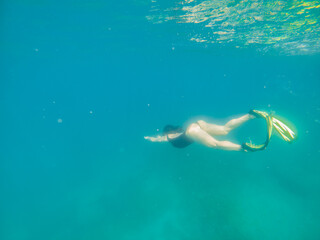 Fototapeta na wymiar woman in snorkeling mask and flippers under water