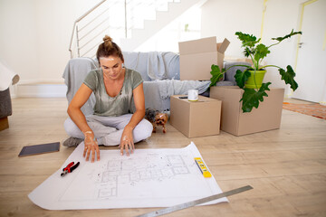 Women in Social Distancing sitting on the floor examining a plan