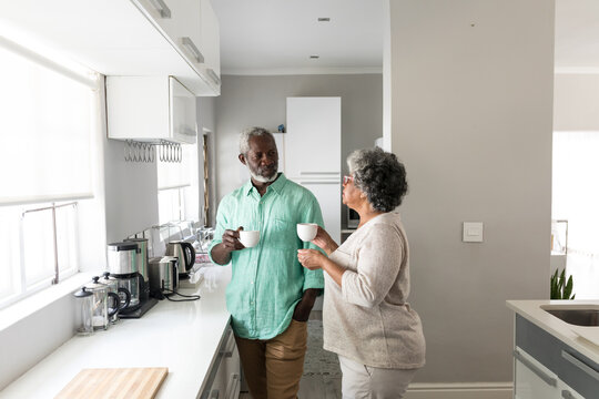 An African American couple spending time together at home and enjoying a beverage